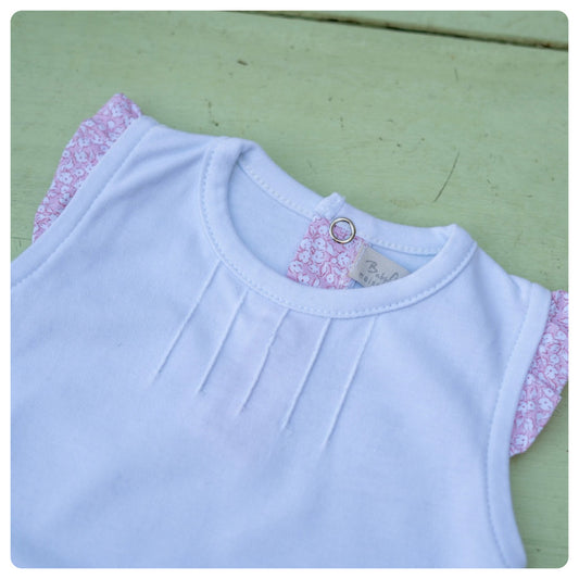 Body algodón manga corta voladitos rosados flores blancas